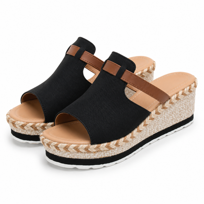 A pair of women's black open-toe wedge mule sandals with brown straps and braided jute-wrapped wedge heels, shown on a clean white background.